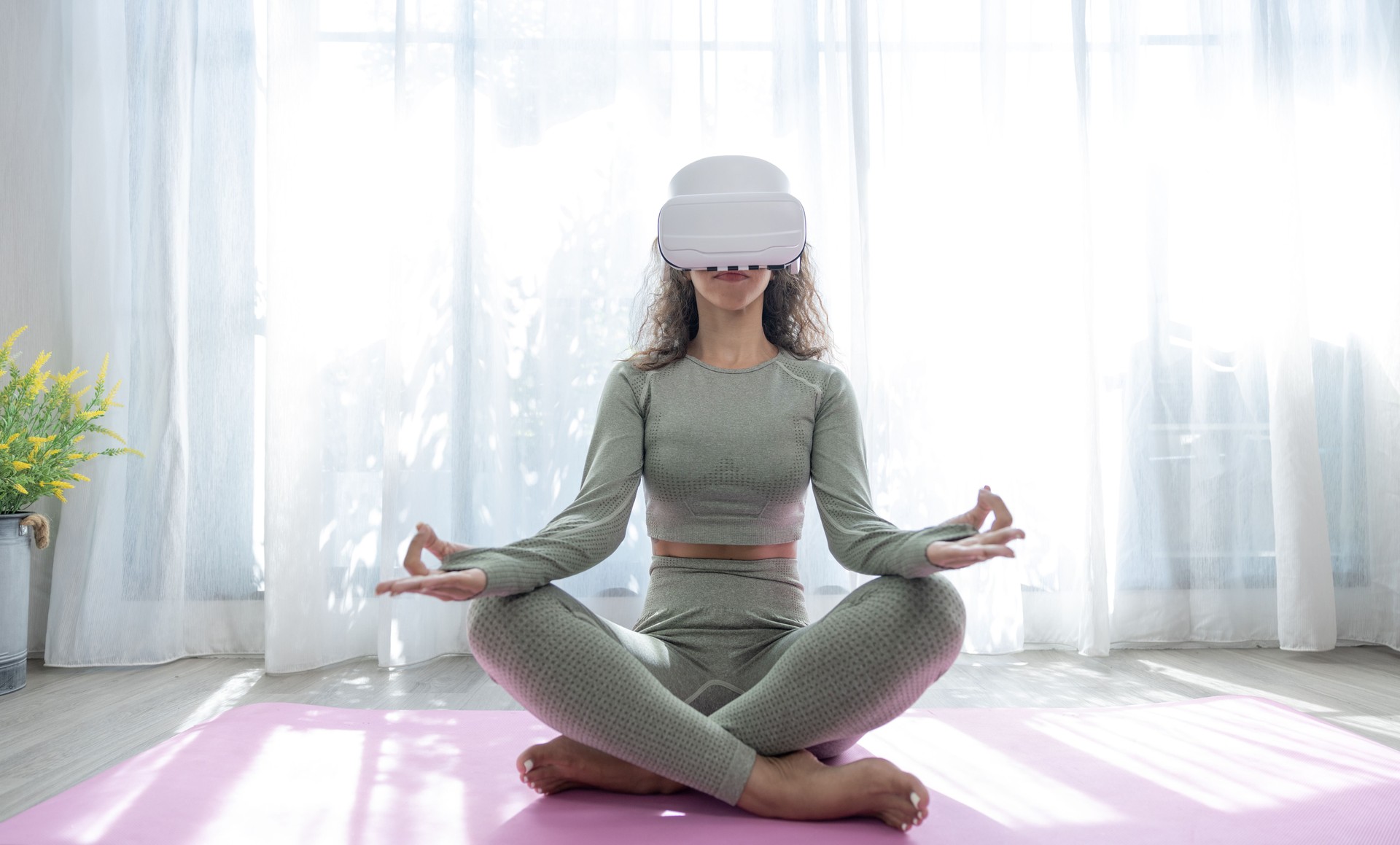 Fitness and lifestyle of the future, VR Yoga, Beautiful woman wearing virtual reality glasses while practicing yoga at home.