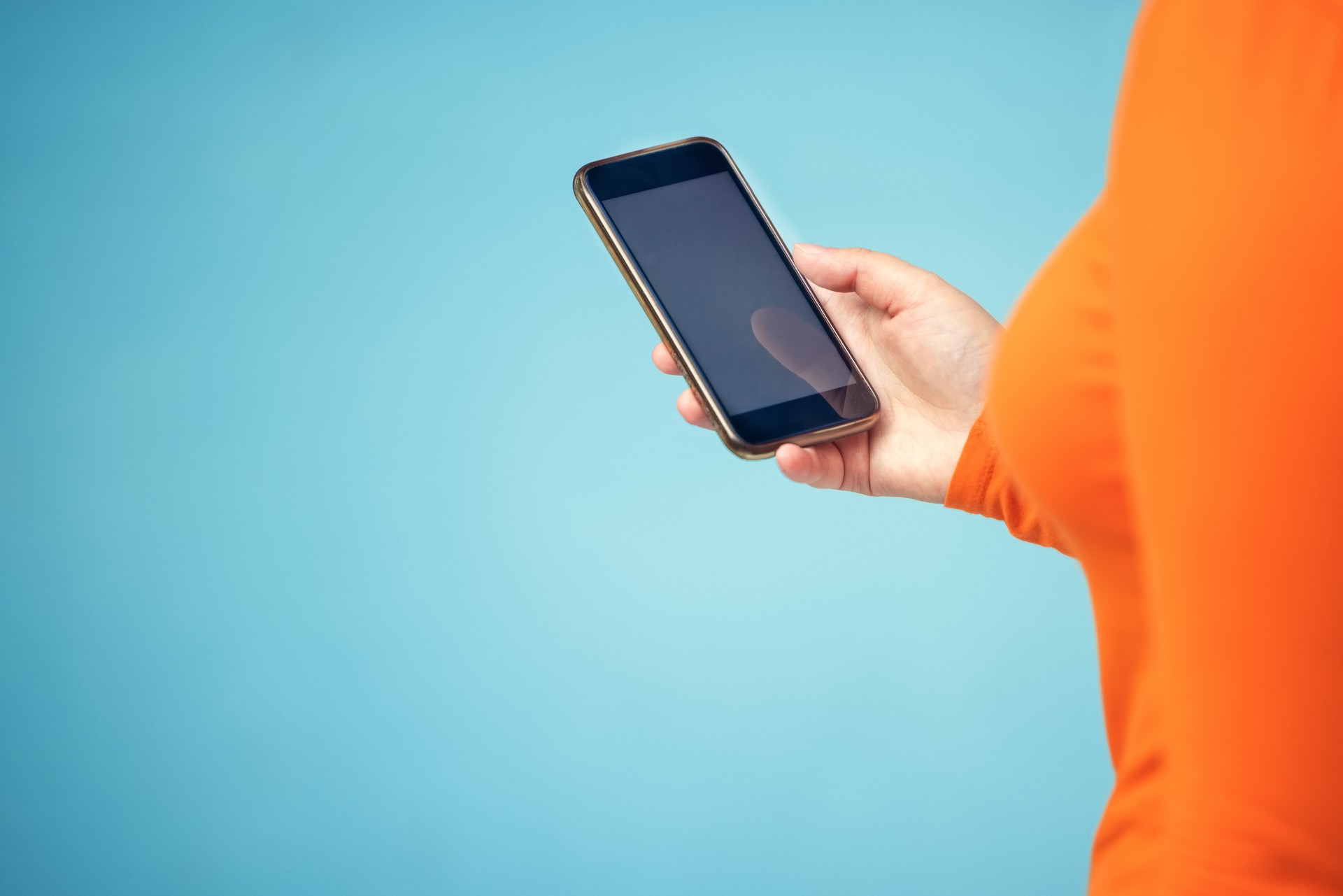 Hand, mockup screen and woman phone for advertising sale, promotion or brand website on internet. Person with smartphone on blue background studio for about us, communication or network connection